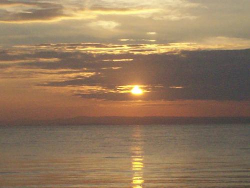 Sunset - This is the sunset in the Southern sky of Cebu, Philippines. I was with friends who joined the Christian Leadership Training Seminar. we had a prayer session on the beach and the scene was just so serene. My spirituality at that moment was raised to a higher level.