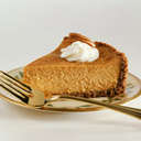 a yummy piece of Pumpkin pie with whipped cream on - piece of Pumpkin pie with whipped cream on top of it