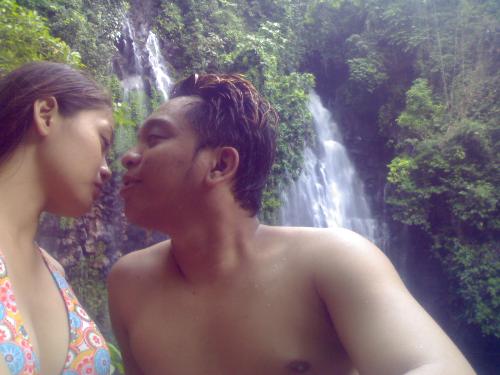a kiss and the waterfalls - this is taken in one of our trips. behind us is one beautiful waterfalls, almost untouch because of its hidden location in the mountains of iligan city, philippines.