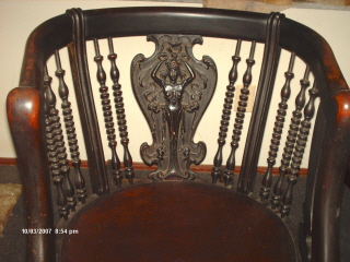antique chair - I don't know much about this set. I know it was in a boarding house that was opened in the 1860's and closed in the 1920's, so the furnite fits in that time line somewhere. I know it is entirely hand carved. The set consist of three pieces, a love seat, a rocking chair, and a regular chair. If you know anything about it I would really love to hear it.