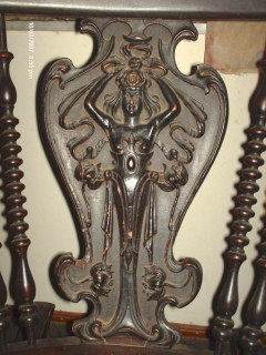 close up of carving - This is a close up of the carving on the set. It looks art deco to me which says 1920's but I thought claw feet were out by then. Each chair has a single carving but the love seat has 2 carvings. All the carvings are as close to identical as hand carved items like this can be.