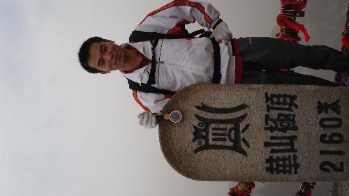 I am standing on the peak of Huashan Mountain - On March 31th,2007,my friends and I climbed Huashan Mountain.This photo is that I standed on the West peak of Huashan Mountain ,which is the highest one of peaks of Huashan Mountain. Look at ,the altitude is 2160 meters of elevation.