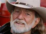 Willie Nelson -   Willie (Hugh) Nelson Biography (1933– ) Print this article     Email this article          RELATED WORKS  Albums  1966 Country Music Concert  1968 Texas In My Soul  1970 Laying My Burdens Down  1971 Yesterday's Wine  » More works  Country music singer and songwriter, born in Fort Worth, Texas, USA. Before he was a teenager he sang gospel in a Baptist church and played guitar in polka bands, but he also absorbed both pop and jazz music. Writing songs in Nashville in the 1960s, he helped the country music revival but he did not get much recognition for his own singing. He relocated to Austin, TX and also reconstructed his image, adopting his trademark beard, headband, earring, and blue jeans. At first he won over a largely youthful audience, especially with his annual ‘picnics’ like mini-Woodstocks, but gradually he broadened his appeal to an adult public. A widely popular, eclectic performer, he recorded jazz standards, country-rock, and gospel in his distinctive singing style, with its bluesy, off-beat phrasing. In the late 1980s he was briefly in trouble with the Internal Revenue Service for falling behind in his taxes, but he resolved that problem and resumed his role as something of a national country-music icon, in part because of his generous appearances at benefit concerts