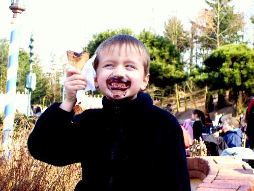 my son at disney - My mum, son and i went to euro disney in 2007. it was packed and the queues were emormous. we decided to have a rest before one of the rides and had a chocolate ice cream as you can see!! we were there for only one day but found it hard to come away. slept for 2 days solid afterwards!