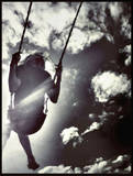 a child on a swing - this is a photo of a child that is on a swing trying to reach the sky
