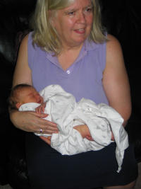 Granddaughter at 1 day old - This is a photo of me and my granddaughter when she was one day old. Cute isn't she? She was a home birth. No my daughter-in-law had a mid wife.