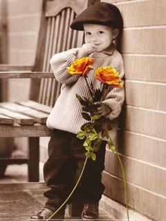 Cute boy - Little boy waiting with flowers on his hands