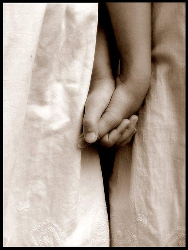 sisters holding hands - i thought that this picture was very touching. its a picture of two sisters holding hands. it shows a bond of togetherness.