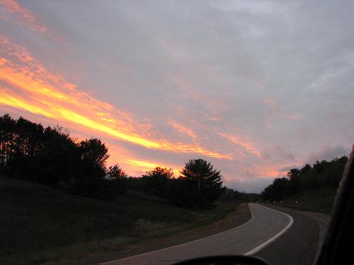 Sunset along the Interstate Highway - I took this shot as I was entering a four lane highway. I pulled over and rolled down my window. I liked the colors and the the pattern fo the clouds.