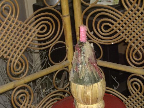 A really old candle in a bottle.  - Most wax has fallen off. It was once very bright. I still love it.