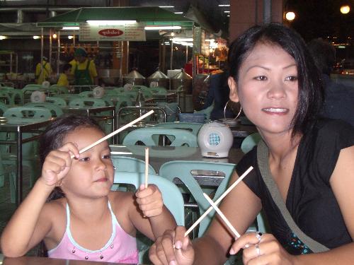 My family - Chopstick fight - blue corner - our daughter Cherry, red corner - my wife Wi.