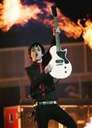 Best guitarist ever! - This photo shows the worlds best guitarist, Billie Joe Armstrong from Green Day, holding up his instrument of awesomeness, i personaly like his other guitar but w/e its his choice, and fire.
