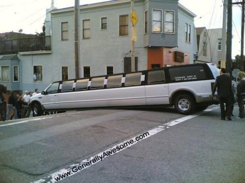 Stretch SUV limo Stuck on Bump - The stretch SUV limo was driving down the hill, and apparently it was too long, so it got stuck, because there's no tires to keep them up and moving!