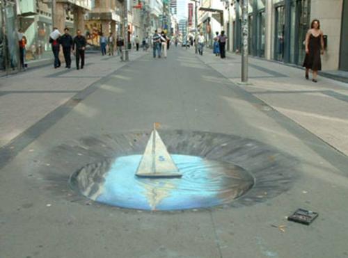 water in the middle of the street - It&#039;s a painting on a street that really looks real.