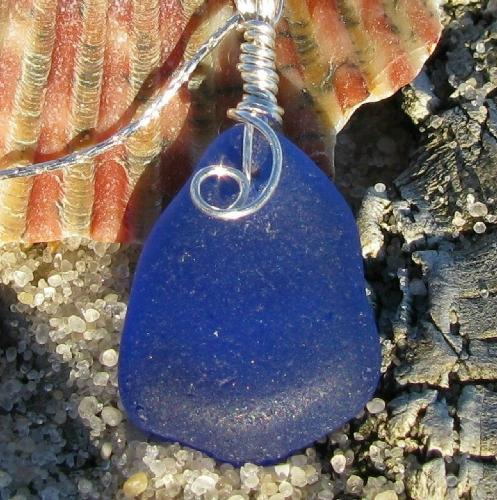 Cobalt Blue Beach Glass Necklace - Found on the beach in northern California, this rare piece of beach glass is the centerpiece of this beautiful necklace. The necklace is wrapped in sterling plated wire and hangs on a sterling silver chain. A piece of jewelry that will draw many comments and complimnets, wait until you see this one sparkle in the sunlight.  This beauty can be found at my shop creationsbyrobin.etsy