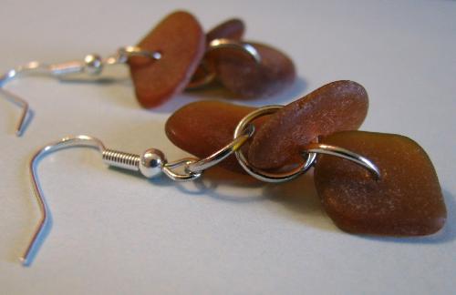 Brown Beach Glass Earrings - 6 pieces of beach glass adorn these earrings ( 3 pieces on each earring) A stunning and surprisingly lightweight item. These will get lots of compliments, especially when they light catches them just right. Brown Beach Glass Earrings - 6 pieces of beach glass adorn these earrings ( 3 pieces on each earring) A stunning and surprisingly lightweight item. These will get lots of compliments, especially when they light catches them just right.