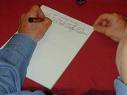 write - A picture of someone writing on a paper. Please rate!