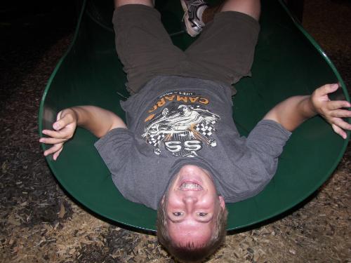 me in a slide - its me chillin at a park. im upside down in a slide