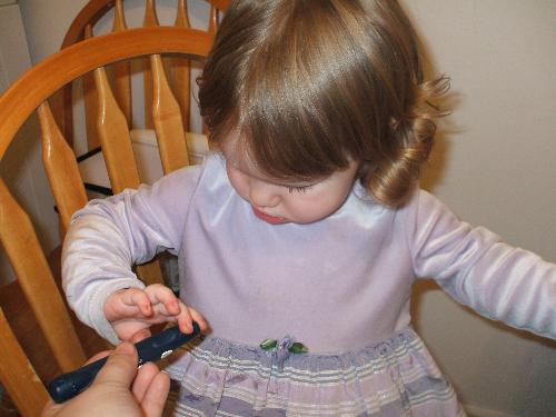 My daughter getting her finger poked - Here is a picture of my little girl, we are checking her sugars