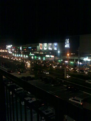 Night Lights - Taken by me using a camera phone.  I was on the top parking lot of one of the malls here in the Philippines and taught of capturing the view from the top.  The picture shows another mall from the other side and of course the dfferent lights coming from automobiles and mall advertisements