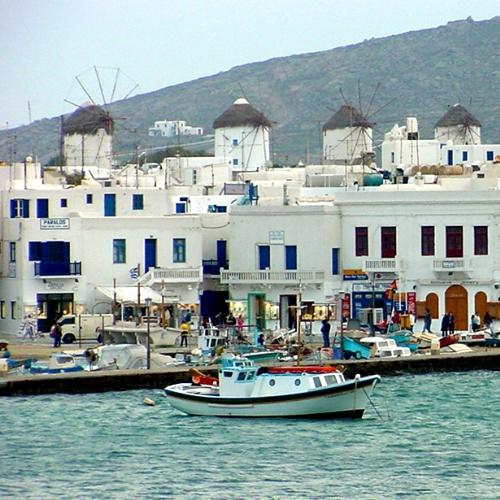 Fishermen Caiques and Windmills - View of Mykonos in the Cyclades Islands of Greece.