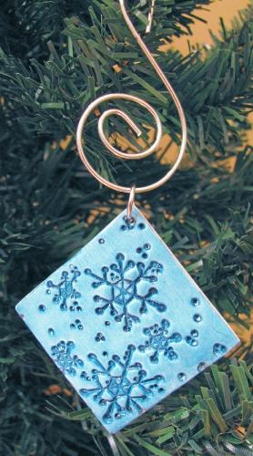 Snowflake Ornament - Made with polymer clay, etched and painted. I then applied a few generous coats of gloss finish to help rpotect the piece. A 2' long ornament hook was attatched.