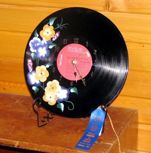 record clock - Since it is hard to find real record players and there are tons of old 33's out there I found a use for them as a clock. Flowers can be painted to match your color scheme, and clock mechanism can be bought at a craft store for around $5. As you can see, I took a blue ribbon on this one that I entered in the county fair.