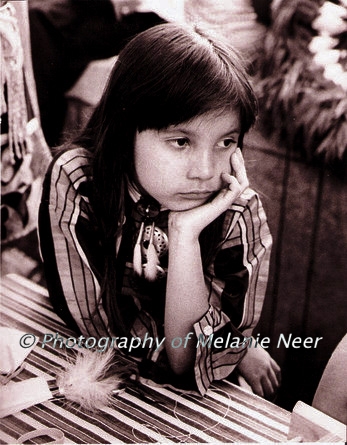 Sepia toned black and white print - image of a osage girl at powwow