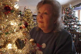 The Christmas Tree Addict  - image of the woman with 42 trees at Christmas