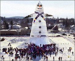 world's tallest snowman - 'Angus, King of the Mountain,' the world's largest snowman, stands tall over a crowd of people gathered to attend a ceremony in Bethel, Maine, in this Feb. 1999 file photo. This time the townspeople will attempt to build the world's tallest snowwoman.