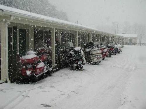 Bikes in the snow - Beautiful pic of bikes at a motel in the snow.