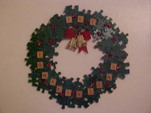 Puzzle Wreath - This is the wreath that I made for my parents this year for Christmas. I had some cardboard laying around that hubby cut into a circle cut-out for me and spray-painted it green. I then hand-painted all the puzzle pieces and glued them to look 3D. Then I took some Scrabble letters and glued them on. It still needed something else, so I added shiny red beads for the 'berries'. Then, to finish it off, I 'found' some items in with all my Christmas stuff and made the bow from that.