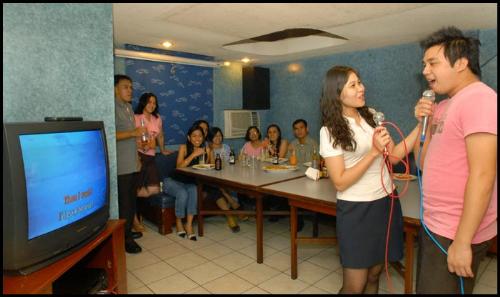 Videoke/Karaoke - An image of people singing using videoke.