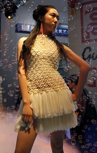 Outfit Made Of Condoms In China - Models parade in outfits made of condoms during a fashion show at the China Reproductive Health New Technologies & Products Expo in Beijing July 11, 2007.