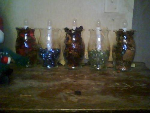 lights - l to r- filled with red apples and cinnamon potpourri, filled halfway with blue stones, filled with purple lavendar scented potpourri, filled with clear stones, filled with vanilla scented potpourri. 6 3/4 inches tall without bulbs, electric