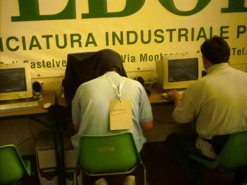 A guy playing counterstrike in LAN at a convention - The signs he bears seems appropriate