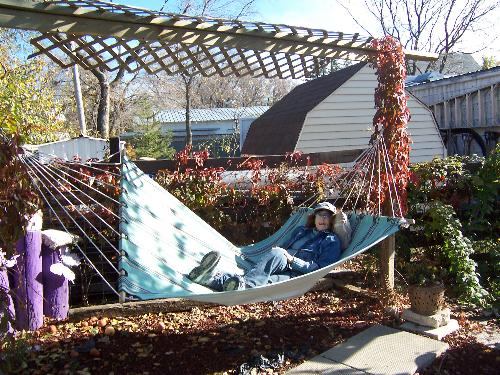 Hammock in the garden...a favorite place - This is a photo of me lying in my hammock on a sunny fall day. The hammock and our garden is among one of my favorite places and spaces...and I don't have to travel anywhere to enjoy it!