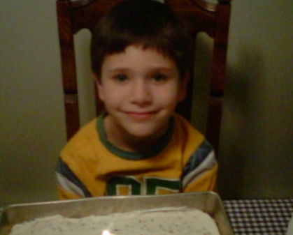 My son with his cake - My son getting ready to blow out his candle on his birthday.