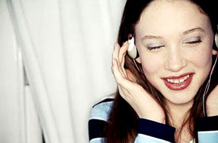 Listening To Music - This is an image of a woman listening to music on her headphones.