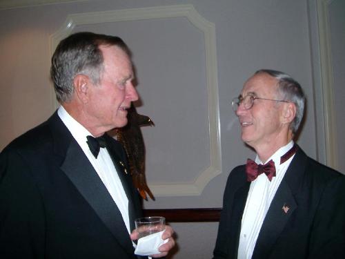 People - Washington, D.C., Sept. 17, 2002 — President George H.W. Bush and Secretary of the Navy Gordon England discuss the contributions made by the USO and the entertainers who volunteer their time for America's armed forces prior to the 2002 USO Gala in Washington, D.C. Service members were honored at the event and the former Commander-in-Chief was honored with the USO's Spirit of Hope Award, named in honor of the legendary actor and comedian Bob Hope. U.S. Navy photo by Capt.Kevin Wensing.[020917-N-3399W-001] Sept. 17, 2002