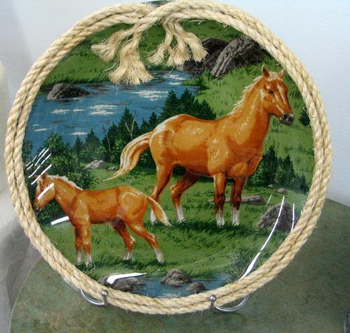 handmade table decoration - This is a picture of a plate I made. I simply took a plain glass plate and decoupaged a piece of material to the back of it that had a nice picture on it and then glued some natural rope around the edge to dress it up. It makes a beautiful table or bookshelf decoration and is a great conversation piece.