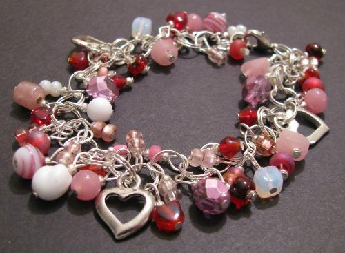 Valentine Sweetheart Bracelet - Made with sterling plated rings, this gorgeous charm style bracelet measures 7 1/2' in length, w/ a lobster clasp. The bracelet is adorned with various glass beads in reds, pinks and white and has3 silver heart charms. A wonderful gift for any sweetheart on Valentine's Day (or just a little something special for yourself!) SOLD