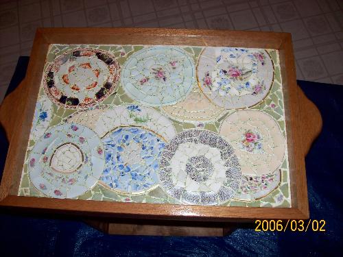 Breakfast Tray - Woodwork was done by my spouse. I sanded, stained, and varnished it myself after the mosaic artwork was done. It was done with vintage china saucers, thereby making it more valuable. Was given as Christmas gift.