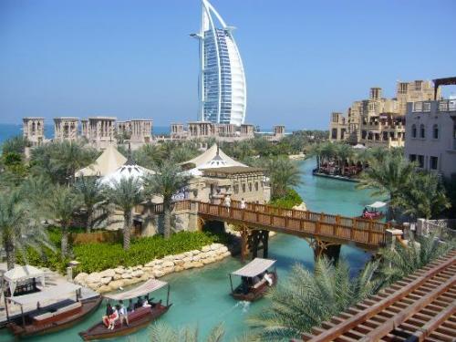 dubai -  river running throught lowlands and skyscrapers in distance