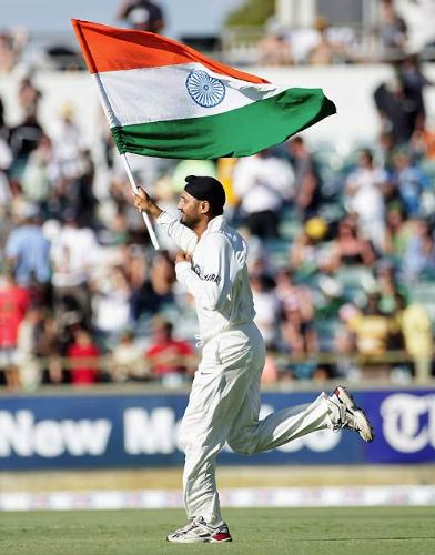 Bhajji and the Tricolor - A lasting image from the Perth test as Harbhajan Singh invades the pitch after India's victory with the Indian flag in his hand!