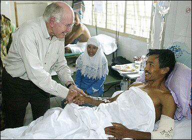 Images of Aceh 2 - Australian Prime Minister John Howard shakes hands with tsunami survivor in Banda Aceh. Health experts warned up to 90% of the millions affected by the Asian earthquake are suffering mental trauma.