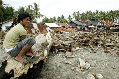 A man sits on debris swept  - A man sits on debris swept ashore by tsunami following an earthquake in Muara Maras, Bengkulu, Sumatra island, Indonesia, Thursday, Sept. 13, 2007. Three powerful earthquakes jolted Indonesia in less than 24 hours, sending a three-meter (10-foot)tsunami crashing to shore, damaging hundreds of houses and terrifying residents. At least 10 people were killed in the tremors, which were followed by dozens of aftershocks.