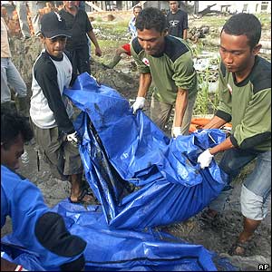 indonesia - Although half a year has gone by since the tsunami struck, officials say corpses are still turning up in Here members of the Indonesian Red Cross remove a recently-discovered body in Kampung Mulia village in northern Aceh on 15 June. The precise number of dead may never be known.