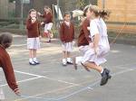 Skipping in the Playground - Children playing skipping games in the playground and chanting rhymes at the same time,no doubt.