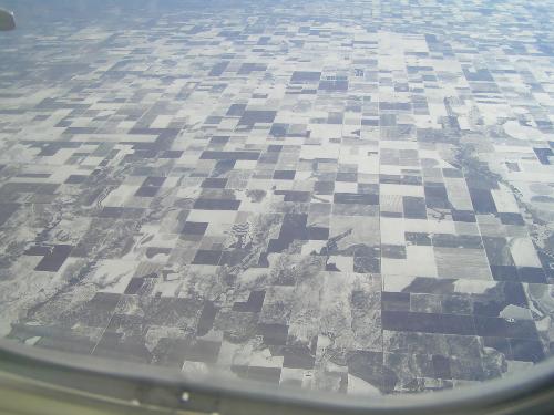Farmlands from the air. - This picture was taken from an airplane on a very clear day. The lands were divided into sections for farms. Some sections were snow-covered which made an interesting pattern.